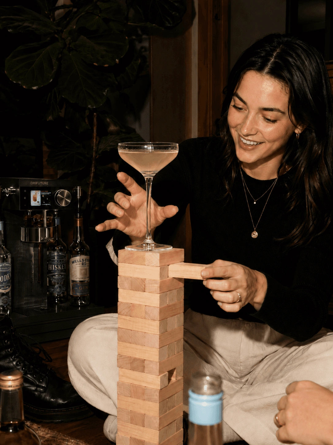 A guest balancing a cocktail moment at home