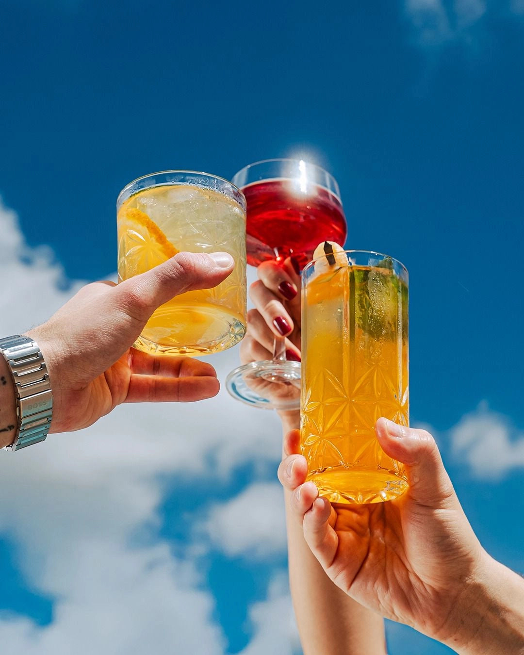 A group sharing cocktails around a table